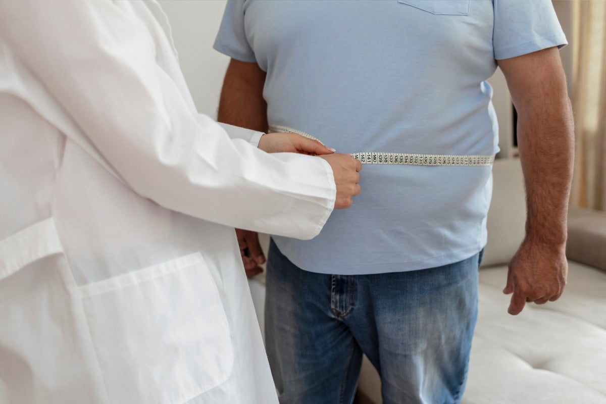 Doctor measuring patient waist