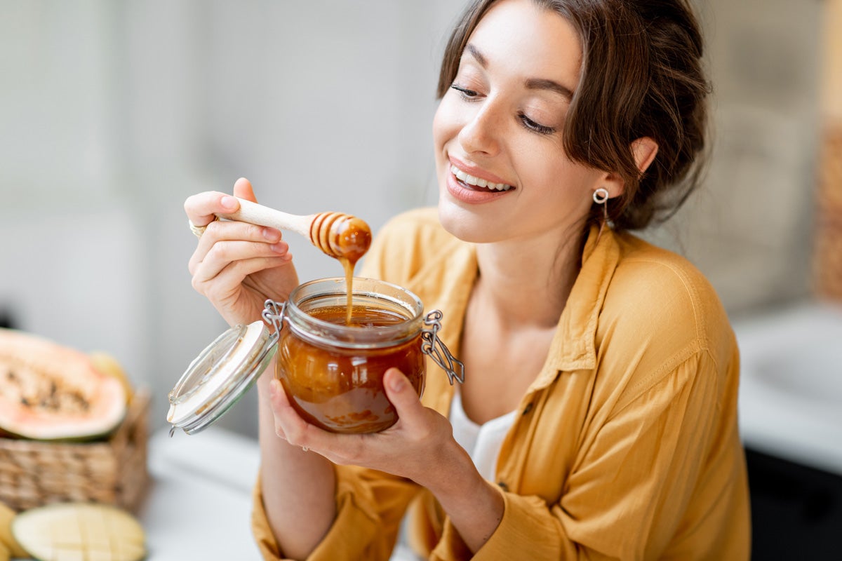 woman dipping honey