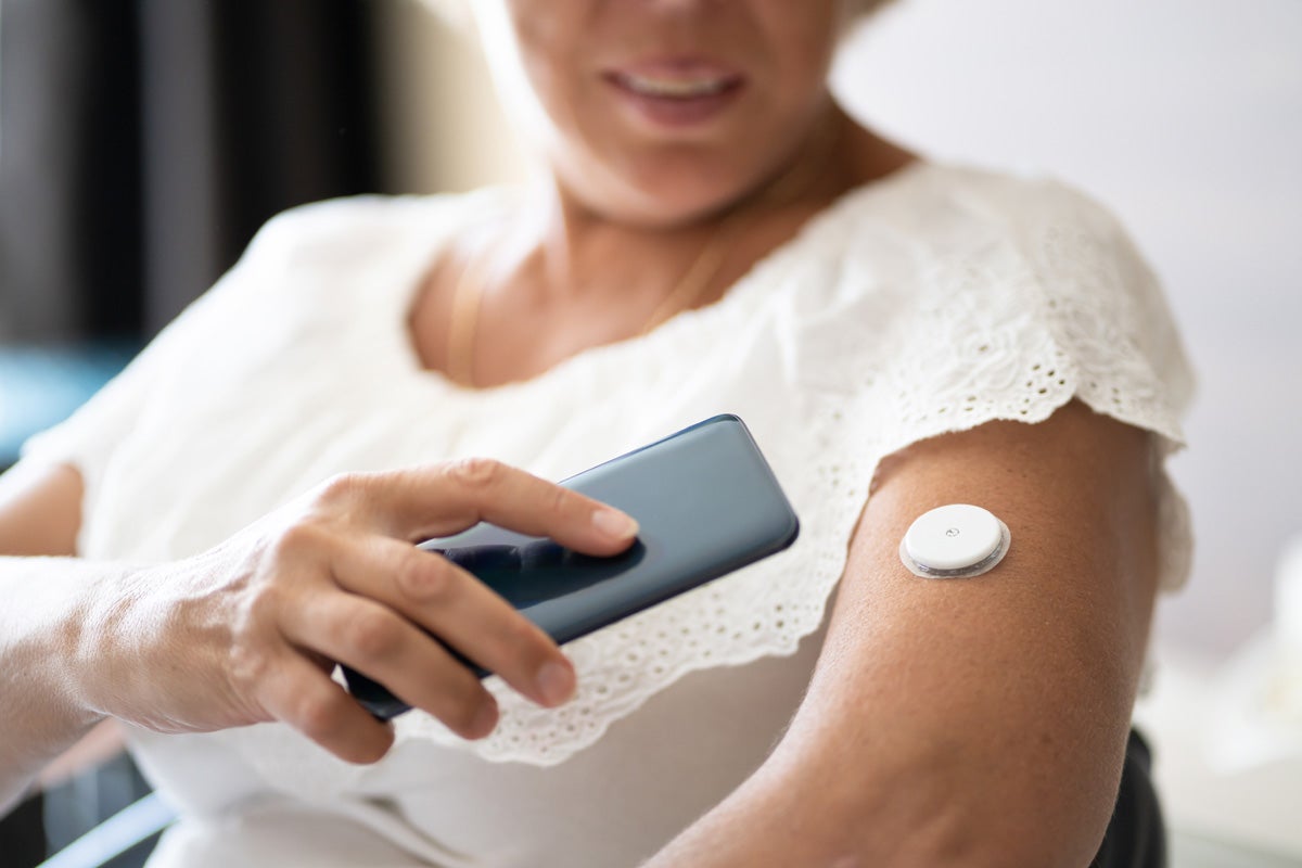 Woman with diabetes monitoring blood sugar level